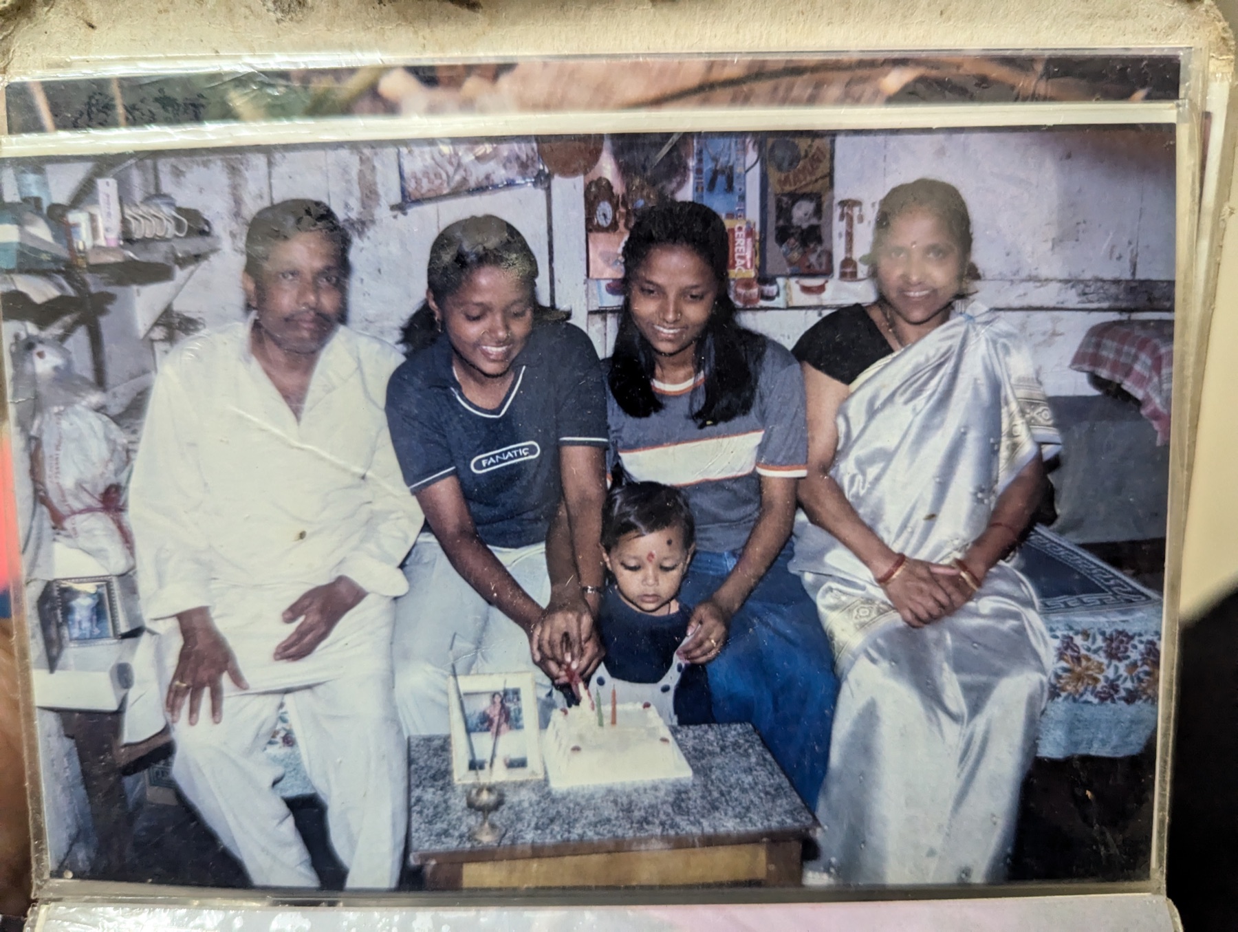 An old family photograph gathered around a birthday cake