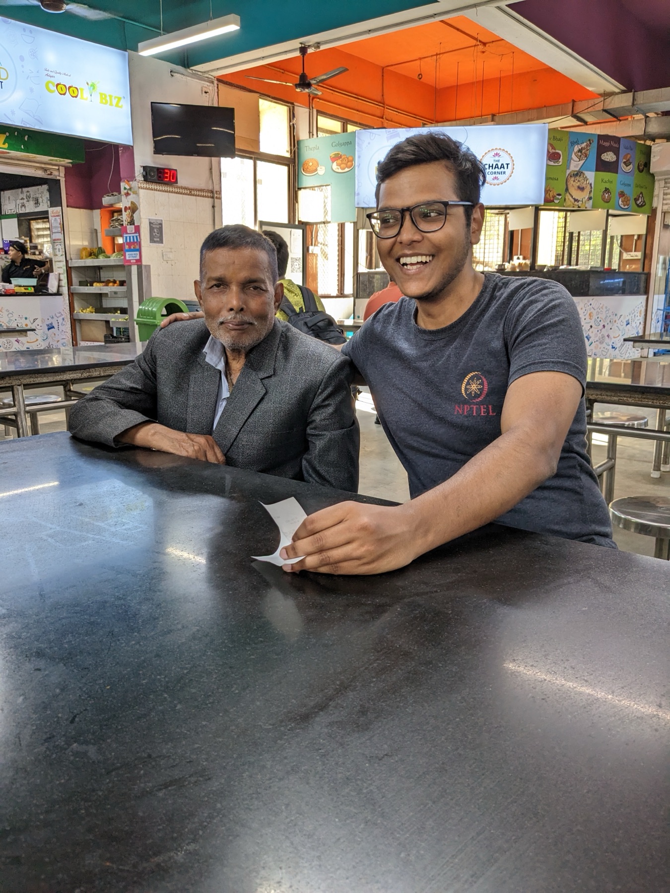 Shri Dharamnath Prasad and his son Amarnath seated together
